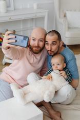 Sam and Ali with young girl on holding a teddy